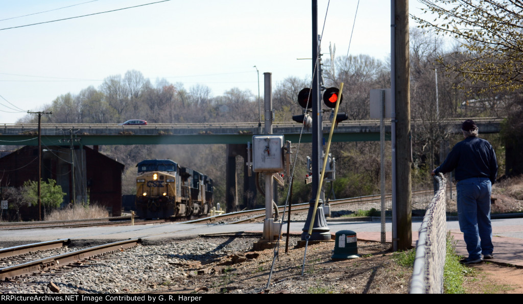 A westbound CSX empty coal train passes underneath the Carter Glass Bridge, US 29 Business.  NS (ex-Southern) Old Main Line veers off uphill to the right.